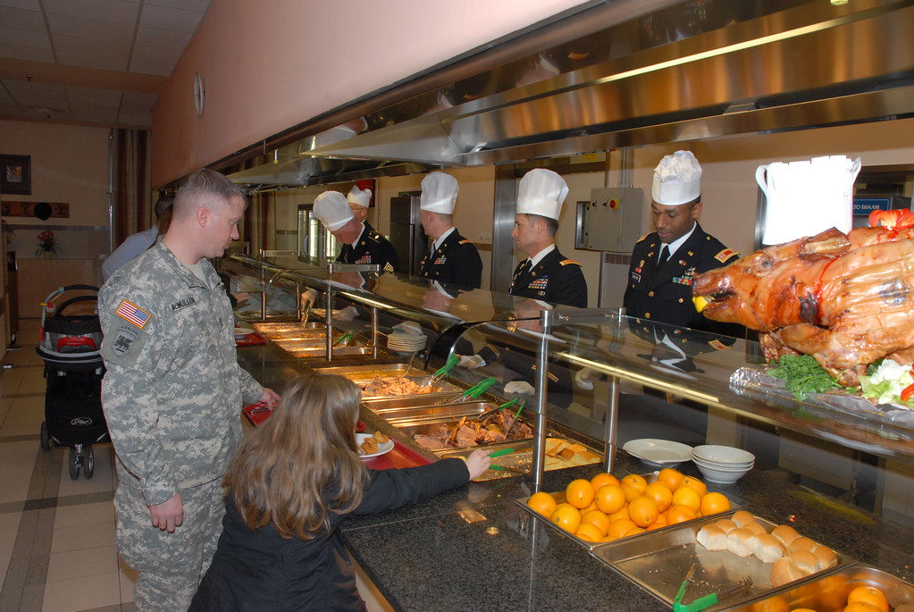 A roast turkey and sides served at a large Thanksgiving dinner