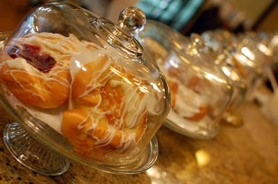 Pastries under a glass dome on a footed stand