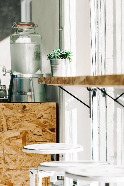 Glass beverage dispenser with a spigot on a table