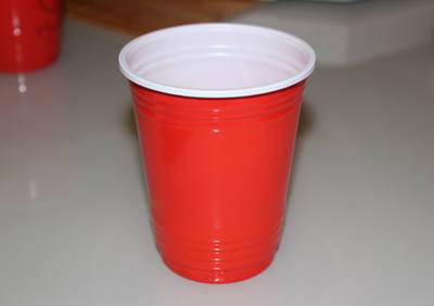 A red plastic party cup on a counter